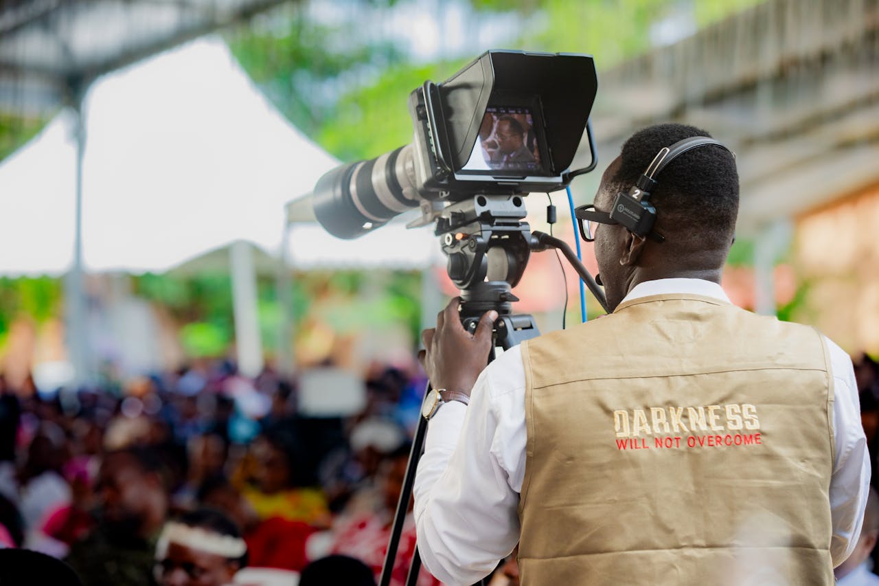 Cameraman filming an outdoor event in Dar es Salaam, Tanzania.